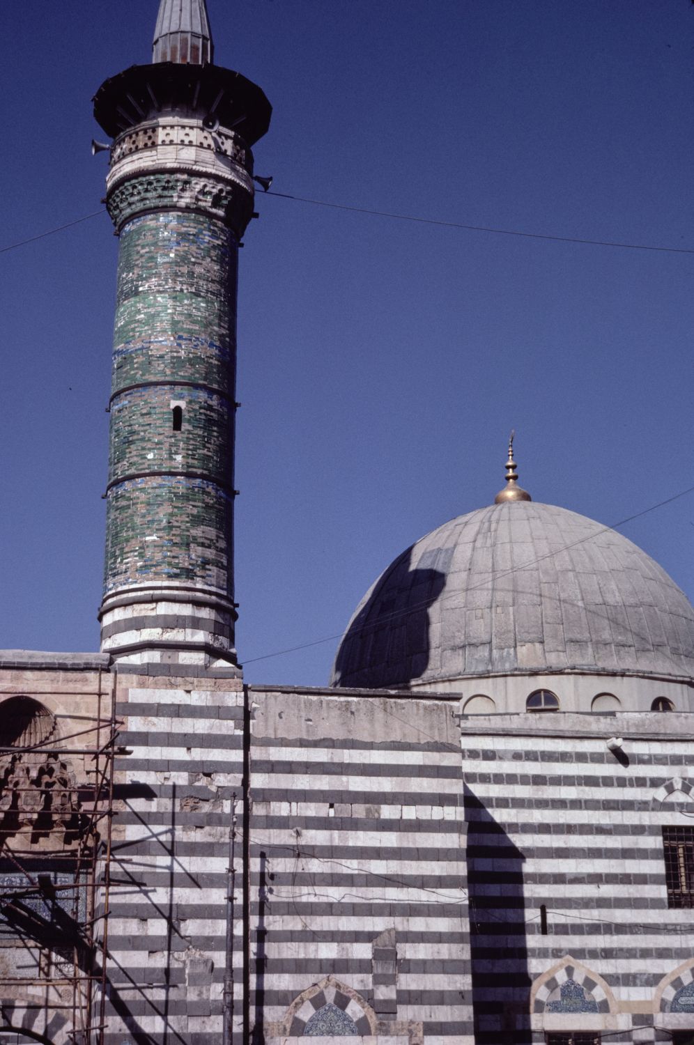 Exterior view of minaret and domed prayer hall.