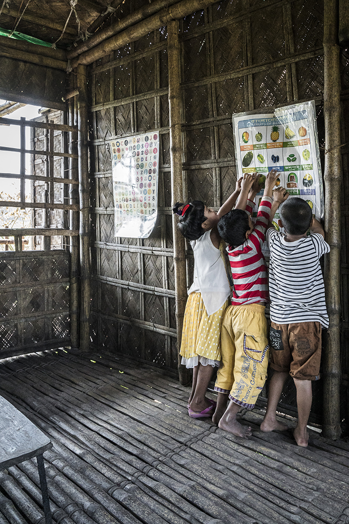 <p>Educational posters are hung on the classroom walls. The use of bamboo allows light and air to penetrate the building, while keeping the heat out.&nbsp;</p>