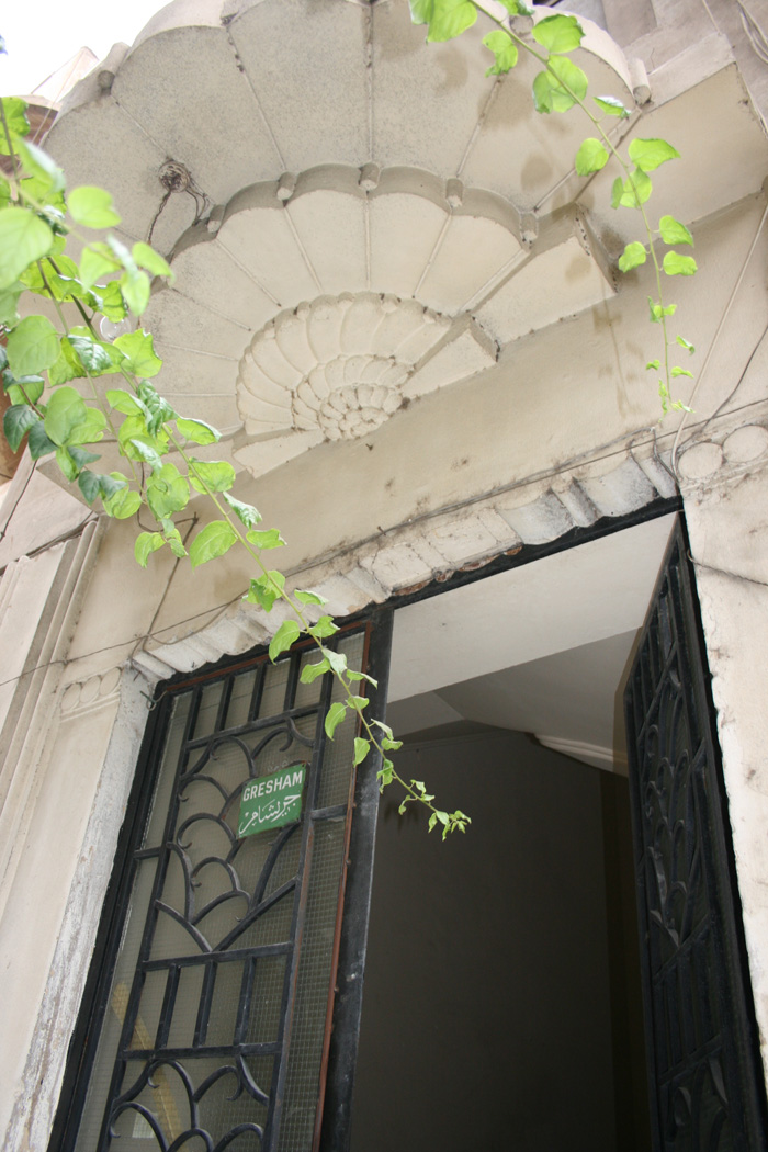 Main entrance with decorative porch and ironwork