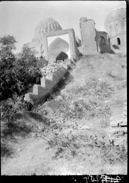 View from the southeast toward the middle chahar taq. The stairs lead up from the entrance. The ribbed dome in the midground to the left belongs to the Amir Zadeh mausoleum. The domed structure to the right is the Shirin Beg Agha mausoleum, before which stand the ruins of Amir Husayn ibn Tughluq Tekin mausoleum
