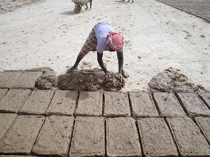 Molding mud bricks out of clay and exposing it to the sun to dehydrate and strengthen 