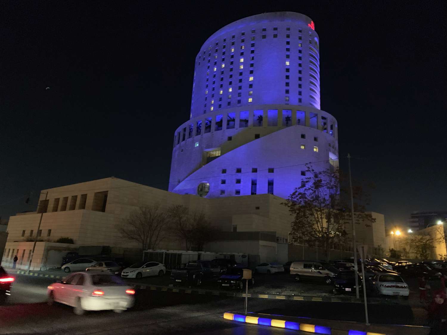 Exterior view of building at night with purple lights.