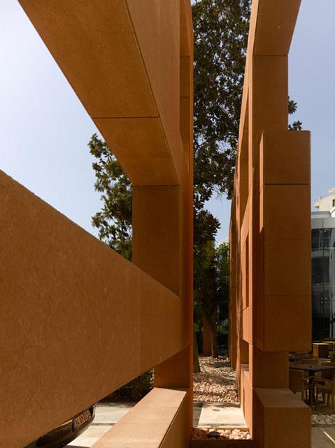  A symbolic terracotta wall emphasises the route to the new entrance