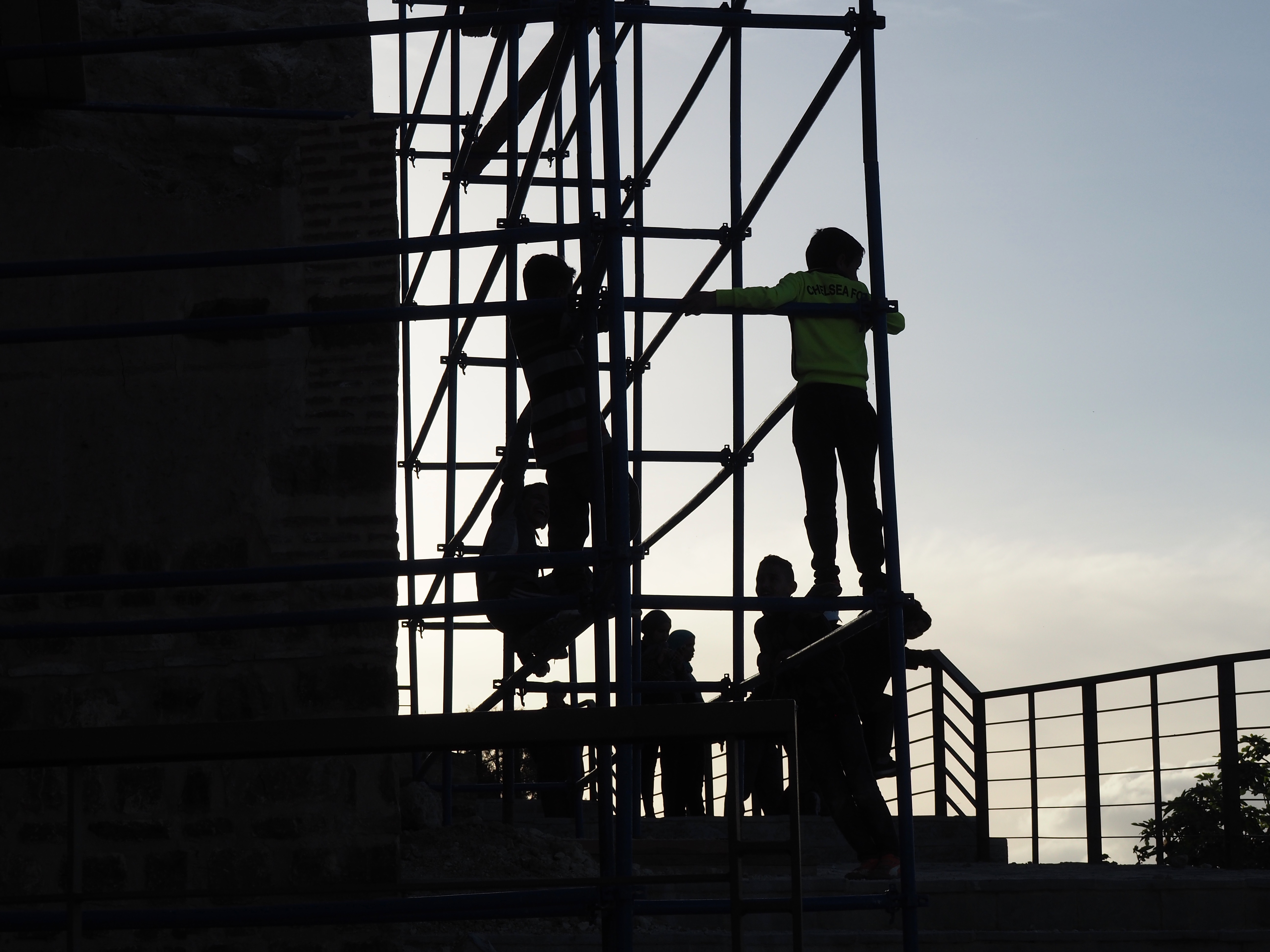 <p>View of children playing on scaffolding during restoration</p>