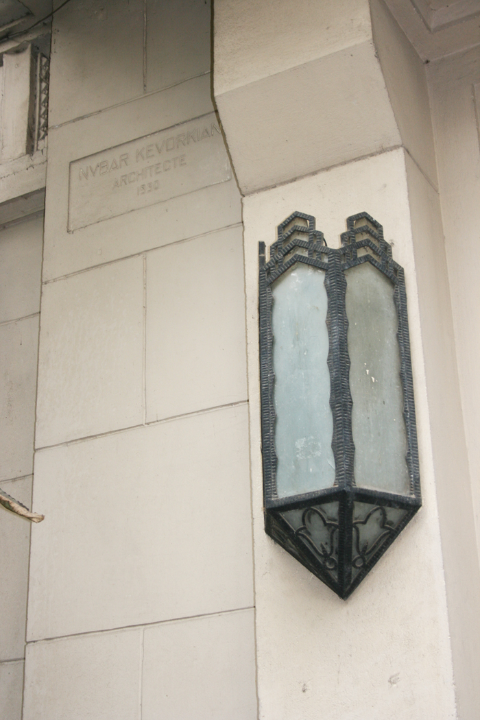 Detail view of the name of the architect and oriental light with conical form