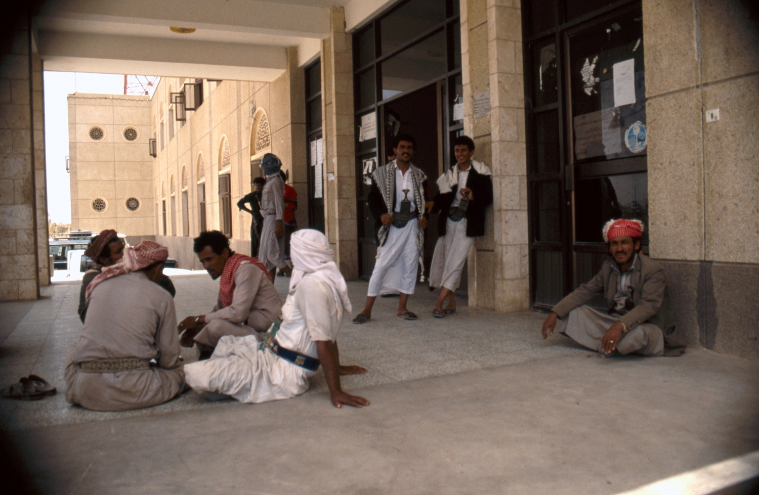 Marib government. Ethnographic views. Men on the portico of an unidentified building.