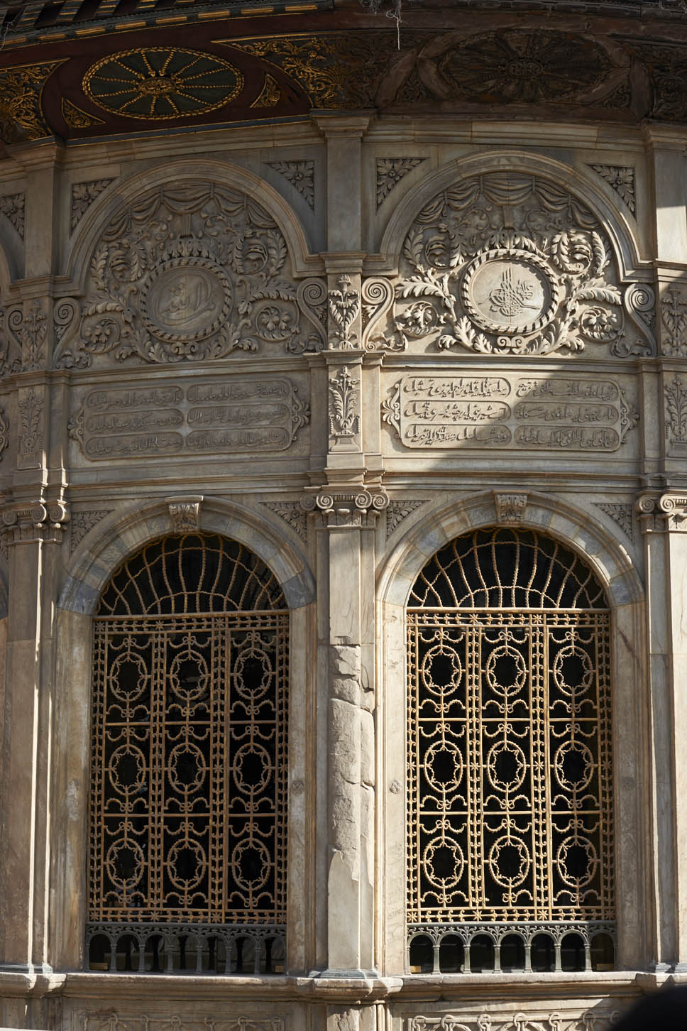 Exterior detail of window grilles and marble inscription plaques