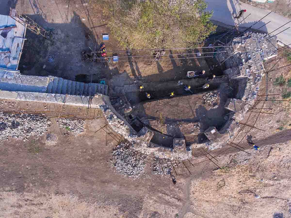 Aerial view over an excavation site around a corner tower
