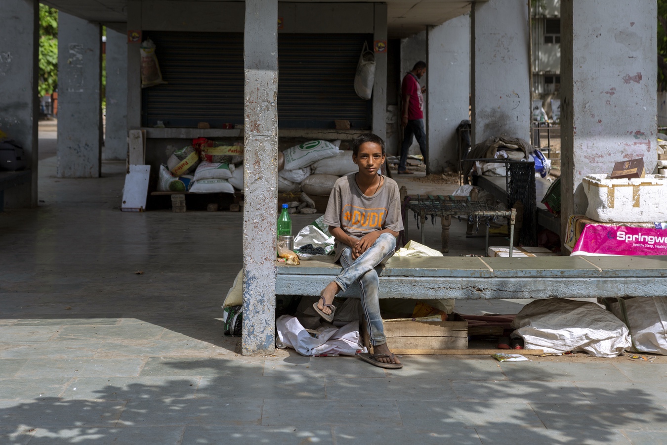 <p>Vijay, a boy born inside the Navrangpura Bus Terminus’ abandoned shop. He runs a bird-feed cart and visits from a village nearby. </p>