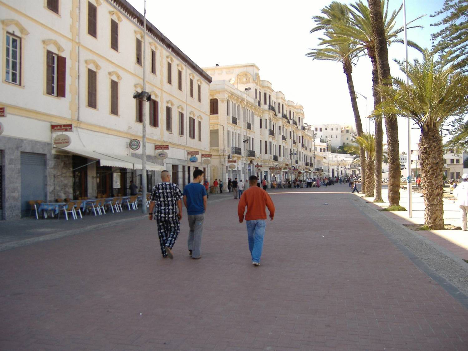 View of pedestrians passing Casa Petri, headed toward the Majestic Hotel