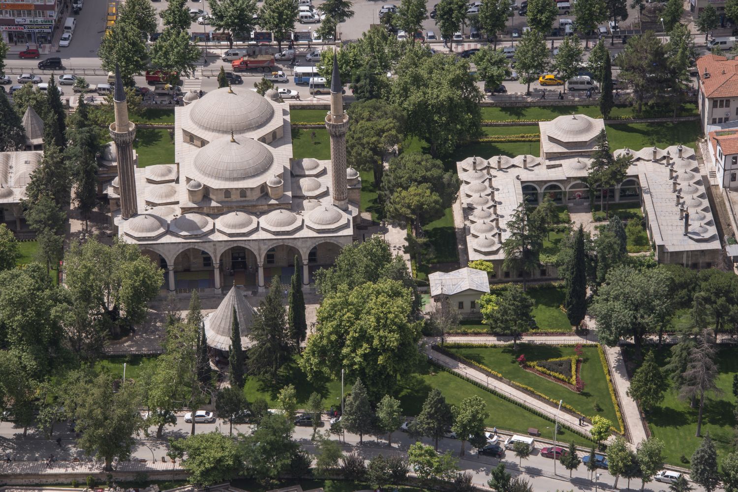 Aerial view over complex from north, showing mosque at left and madrasa at right.