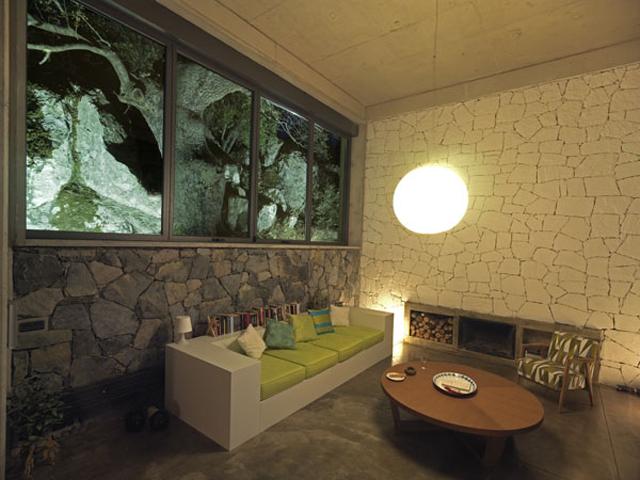 Interior view, living area - the rocks and the olive tree is seen from the rear window.