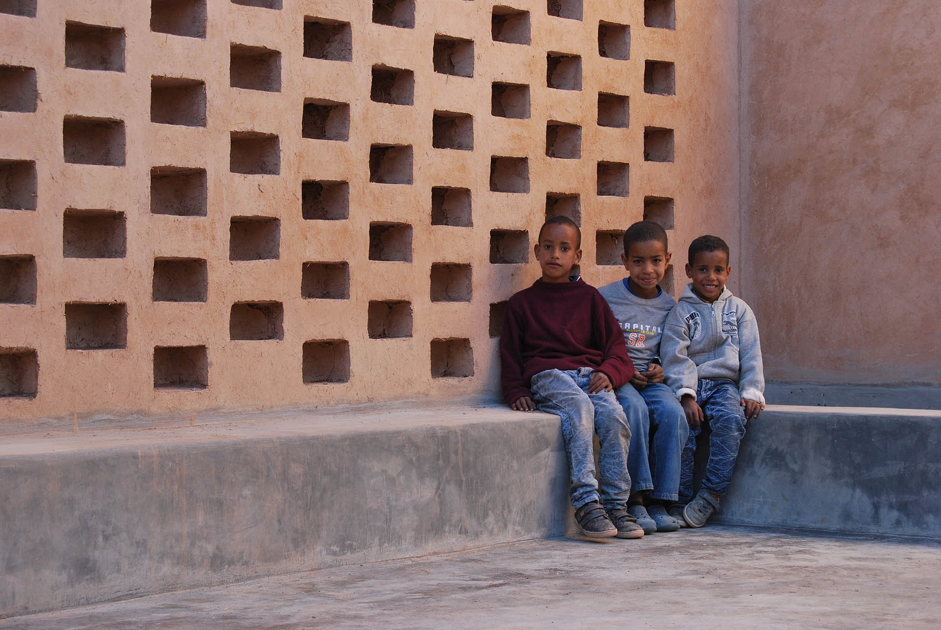 <p>Children sitting in one of the courtyard</p>