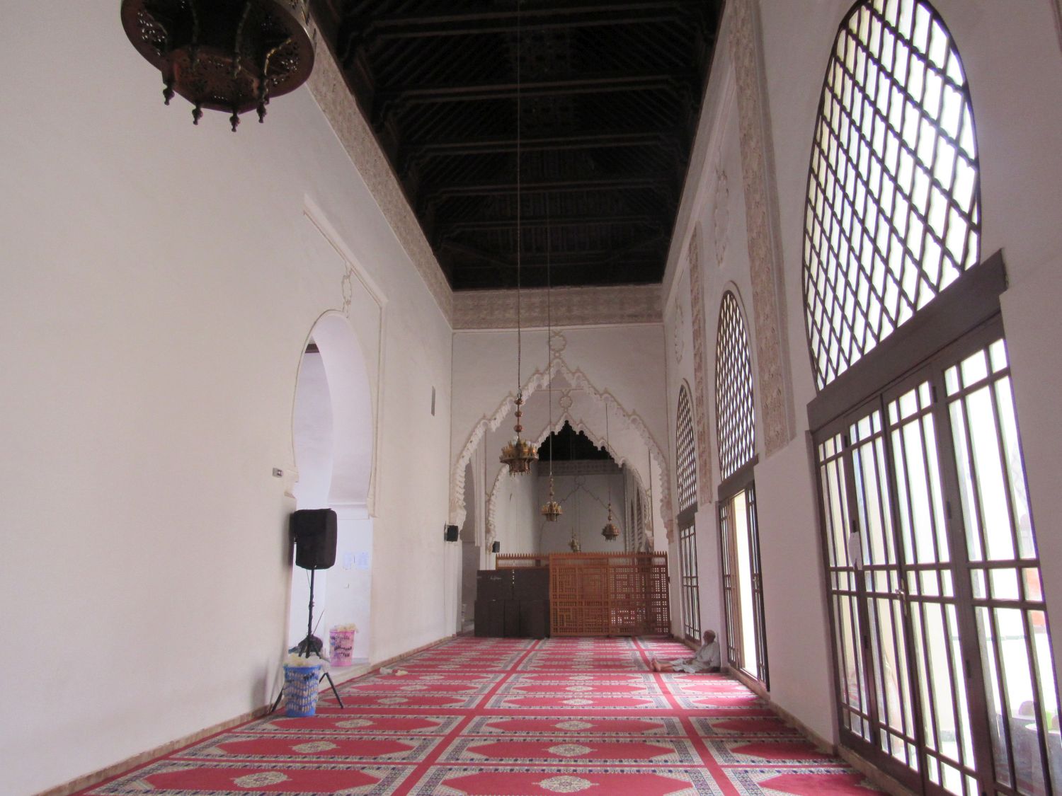 Interior view of the prayer hall with wood ceiling, and carved wood screens