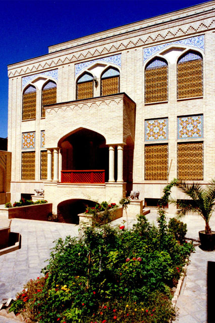 Exterior view showing brick façade with inset wooden screens and tile work