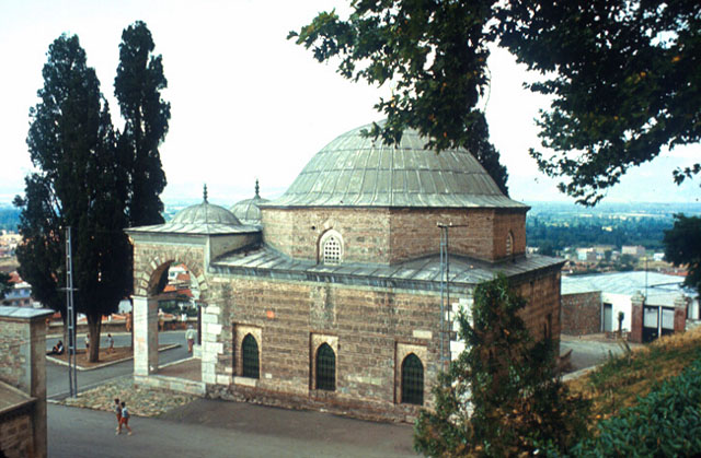 Exterior view of the mausoleum from southwest, with pishtak portal of madrasa visible on lower left