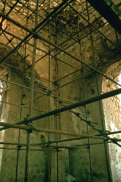 Interior view of a chamber during restoration, showing corner with squinch