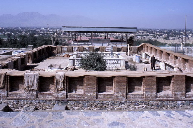 Construction of brick outer enclosure on newly paved stone terrace, with temporary roof over Shahjahani Mosque behind