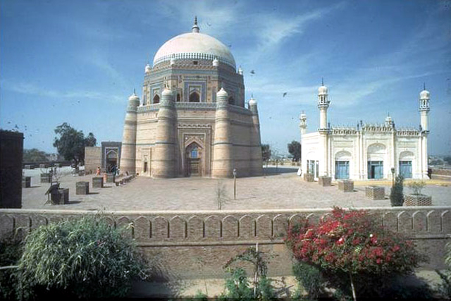 Exterior view from east showing the precinct wall, mosque (right) and the domed mausoleum