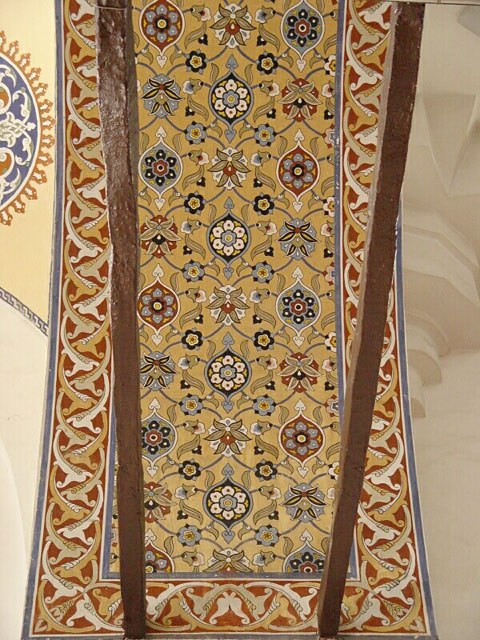 Interior detail, showing painted decoration of arch soffit and wooden ties