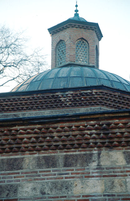 Exterior detail, showing lantern of dome and the triple saw-toothed cornice on ridge of stone and brick wall