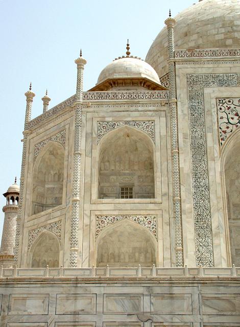 Detail view of the western part of the mausoleum's south elevation, showing the paneled plinth, arched niches, marble cladding and pietra dura work