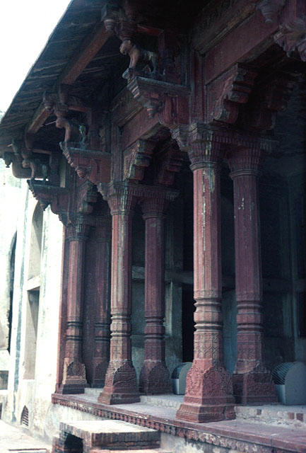 Exterior close-up of column and capital details of building in quadrangle