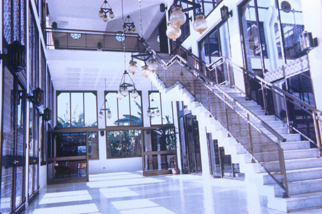 Interior view showing marble and wooden details and hanging glass lamps