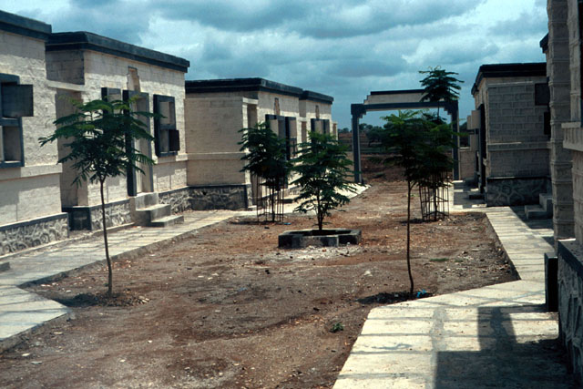 Earthquake Rehabilitation Centres - Exterior view of pathways and gardens that separate buildings