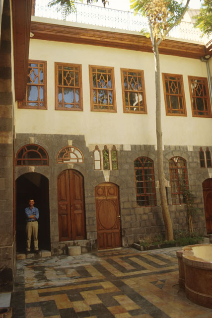Exterior view showing use of stone and wood to form the courtyard