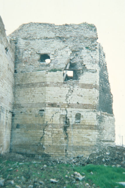 Exterior view showing dilapidated corner tower
