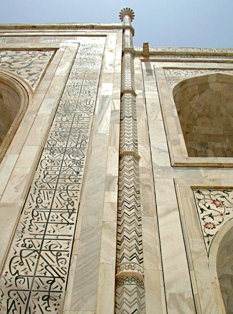 Detail view of mausoleum showing the right half of the central pishtaq, engaged column with herringbone pattern, and thuluth inscription on the frame