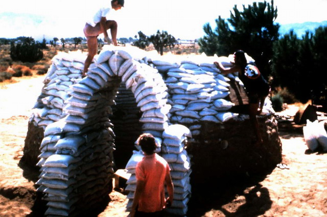 Sandbag Shelters - First completed sandbag dome prototype later tested for seismic resistance, standard sandbags, earth and barbed wire
