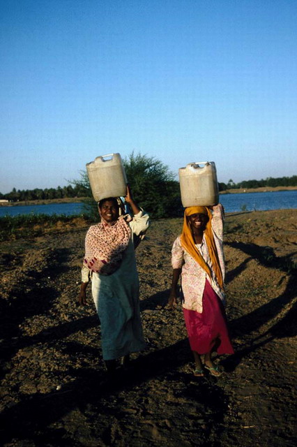 Women carrying water from the Nile before the water project