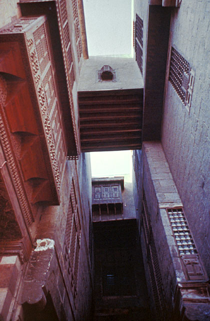 Exterior view looking up at bridge connecting the two houses across the alleyway