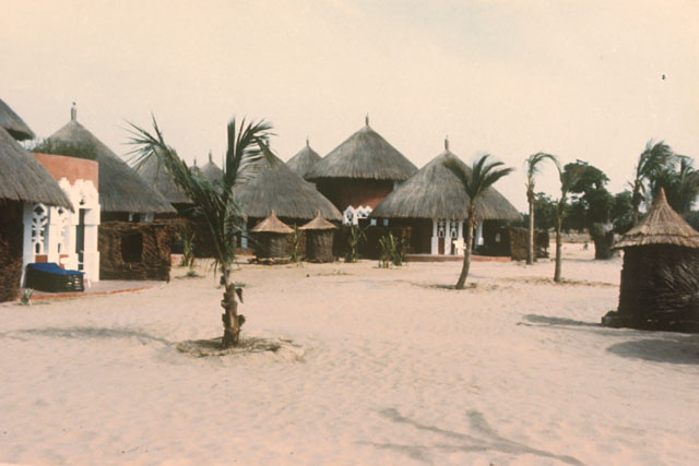 Exterior view showing placement of thatch roof huts along beach