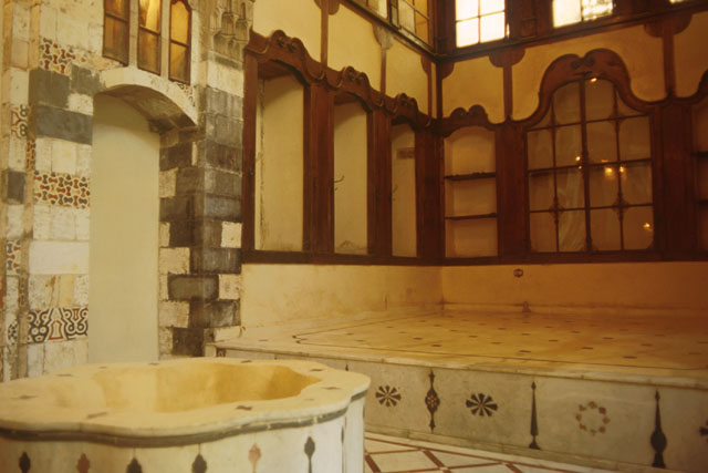 Interior view showing inlaid marble and wood built in furniture of qa'a