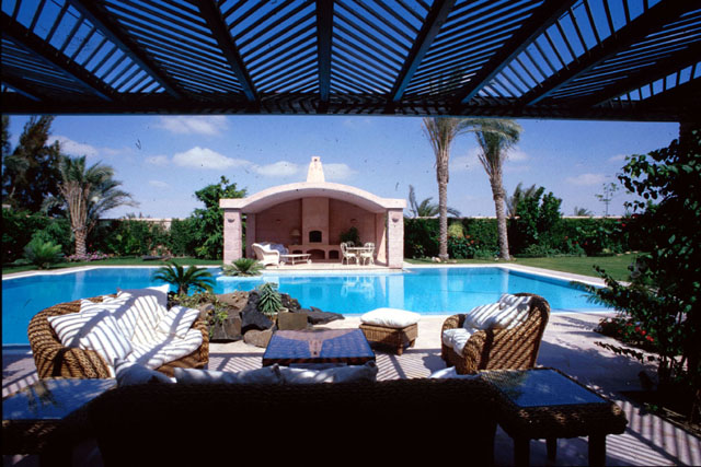 View from covered patio across pool