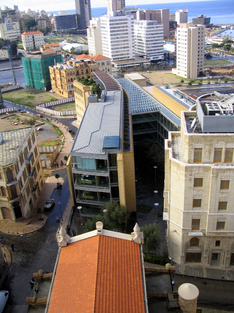 Bank Audi Headquarters - Bank building, as seen from the clocktower of St. Louis Church; the church's red tiled roof and the preserved building are seen in the foreground, followed by a contemporary building composed of two blocks seperated by a garden and an atrium