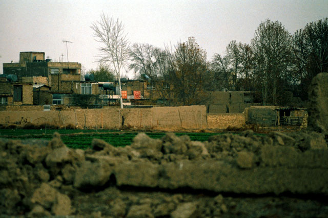 Exterior view showing dilapidated walls and make-shift housing