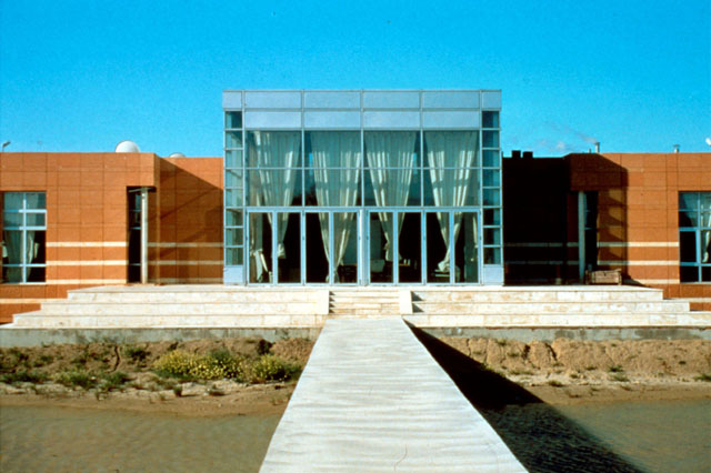ATK Textile Factory - Exterior view showing pathway to glazed entrance