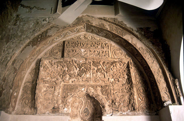 View of the carved stucco arch above the corner mihrab