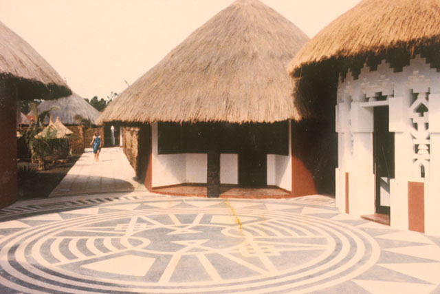 Exterior view showing intricate paving design between huts