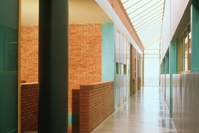 View along corridor showing glazed roof and brick walls
