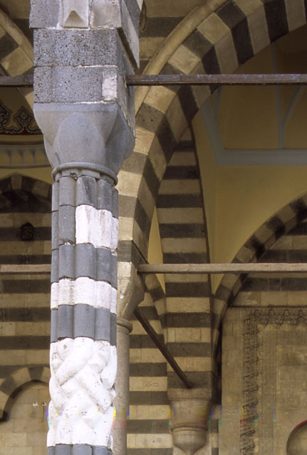 Exterior detail of portico, showing braided molding on column with ablaq masonry