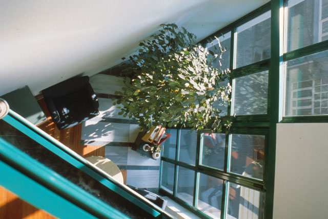 Interior view showing placement between wall and sloped ceiling of windows