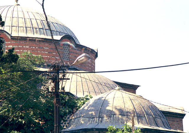 Rum Mehmed Pasa Mosque - Exterior detail showing the main dome and the semi-dome of the qibla annex to the south; the dome in the foreground belongs to the mausoleum