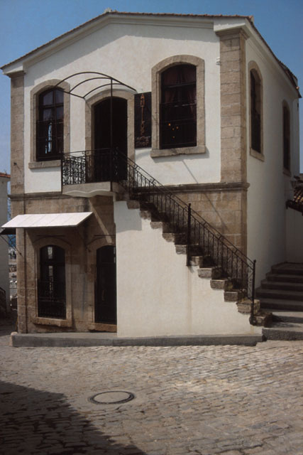 Exterior view to face showing staircase entry to second story