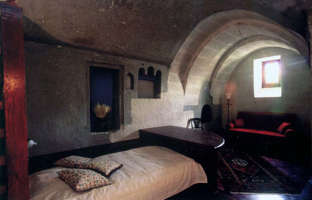 Interior view of rock-carved bedroom with window