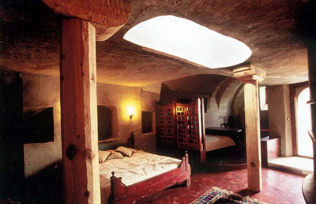 Interior view of rock-carved bedroom with skylight